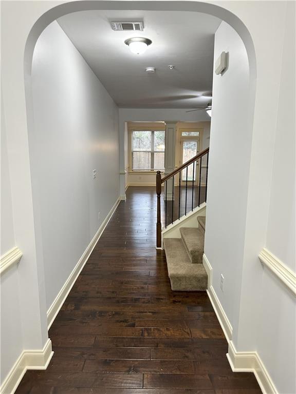 corridor featuring dark hardwood / wood-style floors