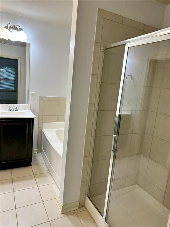 bathroom featuring plus walk in shower, tile patterned flooring, and vanity