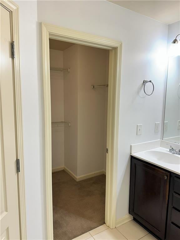 bathroom featuring tile patterned flooring and vanity