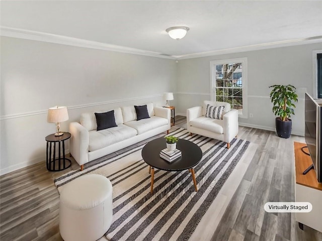 living area with crown molding, baseboards, and wood finished floors