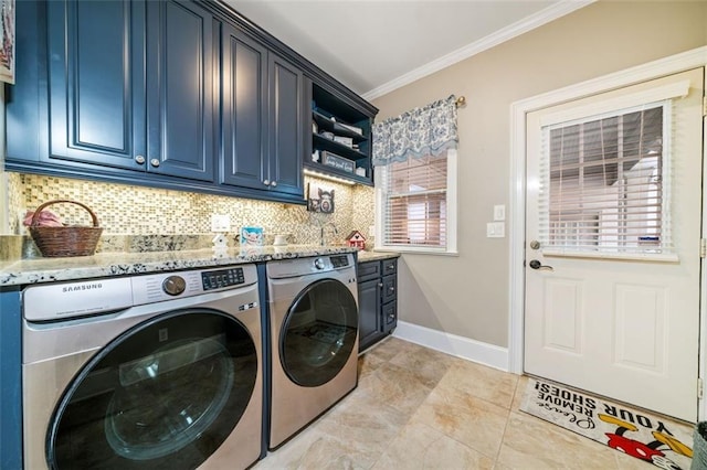 clothes washing area with washer and dryer, cabinets, ornamental molding, and sink