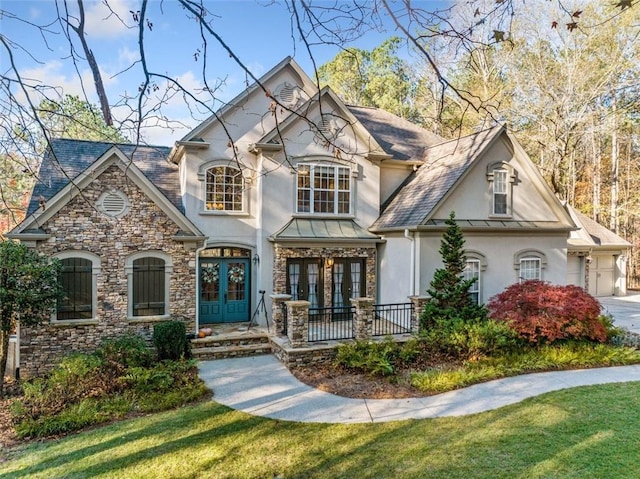 view of front of home featuring a front lawn and french doors