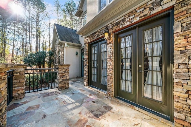 entrance to property with a patio area and french doors