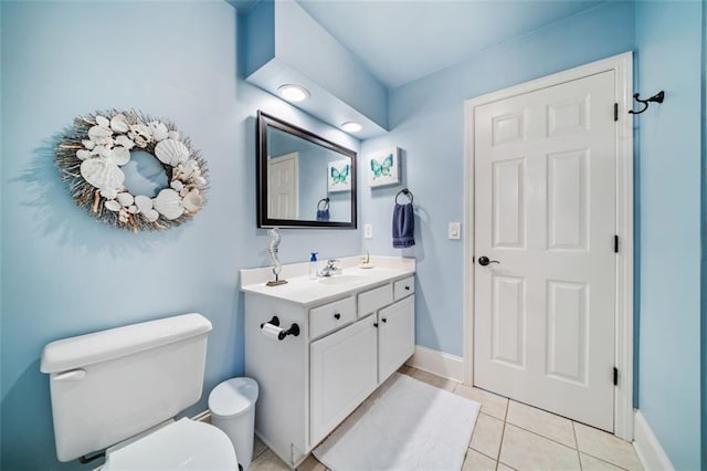 bathroom featuring tile patterned flooring, vanity, and toilet