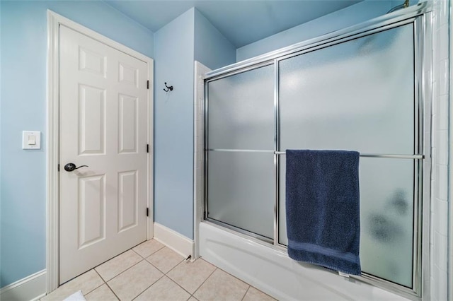 bathroom featuring tile patterned floors and shower / bath combination with glass door