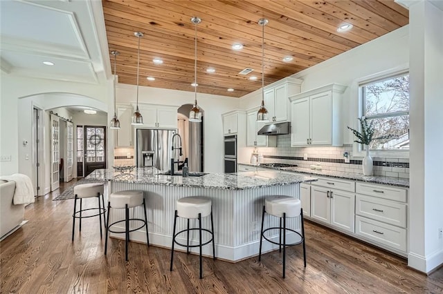 2987 Jefferson St, Atlanta, GA 30341 - kitchen with stainless steel appliances, wooden ceiling, a sink, under cabinet range hood, and arched walkways