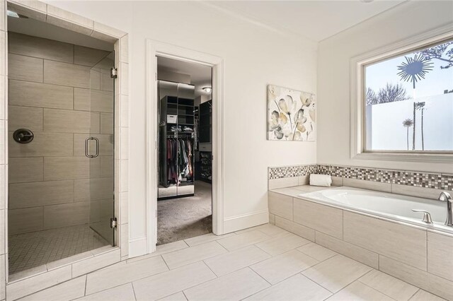 2987 Jefferson St, Atlanta, GA 30341 - full bathroom with a shower stall, a bath, tile patterned floors, baseboards, and a walk in closet