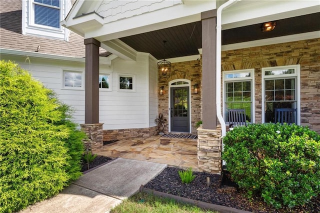 119 Sharp Mountain Crk, Ball Ground, GA 30107 - entrance to property with covered porch, stone siding, and roof with shingles