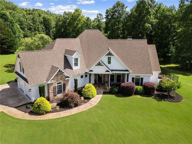 119 Sharp Mountain Crk, Ball Ground, GA 30107 - view of front of home featuring stone siding, a garage, a front lawn, driveway, and roof with shingles