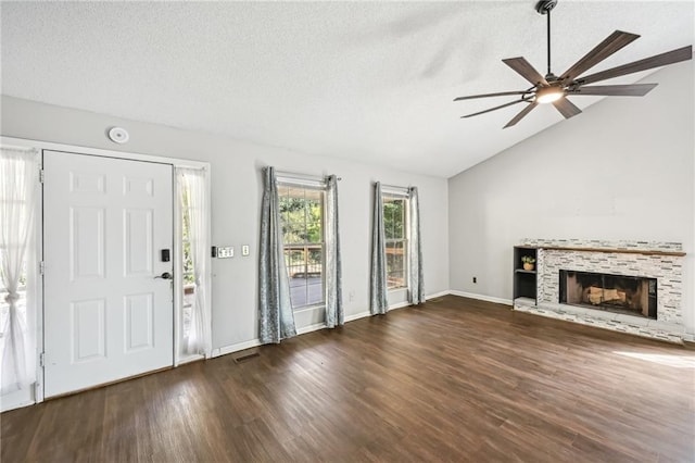 unfurnished living room with a textured ceiling, wood finished floors, a ceiling fan, and vaulted ceiling