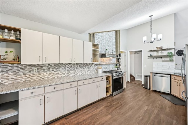 kitchen with an inviting chandelier, open shelves, dark wood-style flooring, stainless steel appliances, and vaulted ceiling