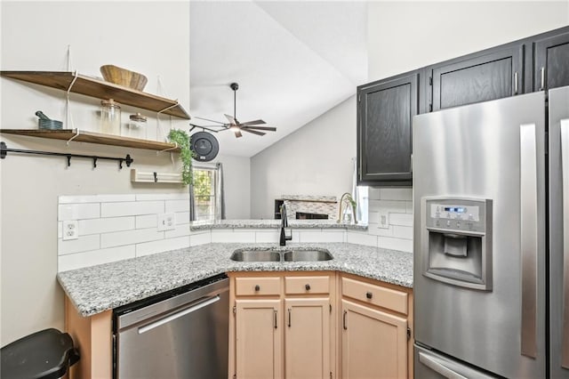 kitchen with a ceiling fan, open shelves, a sink, appliances with stainless steel finishes, and backsplash