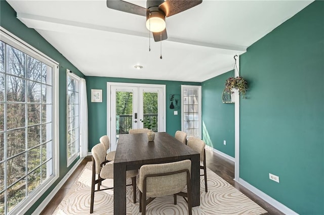 dining room featuring baseboards, vaulted ceiling with beams, ceiling fan, dark wood-type flooring, and french doors