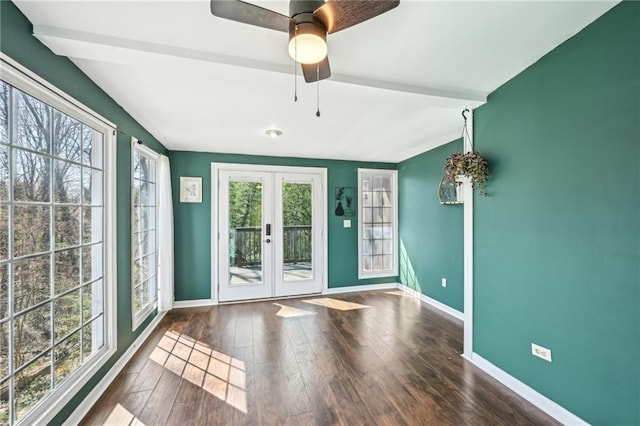 empty room with vaulted ceiling with beams, baseboards, french doors, wood finished floors, and a ceiling fan