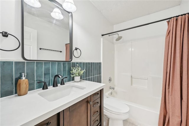 full bathroom with vanity, tile walls, shower / tub combo, and toilet