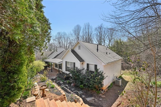 view of side of home featuring a patio area and central AC unit