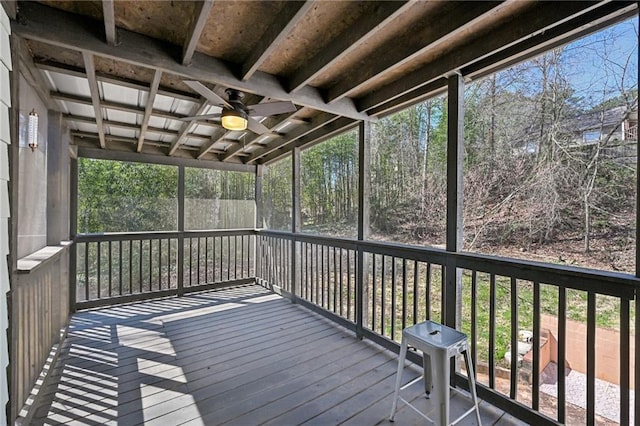 unfurnished sunroom featuring ceiling fan