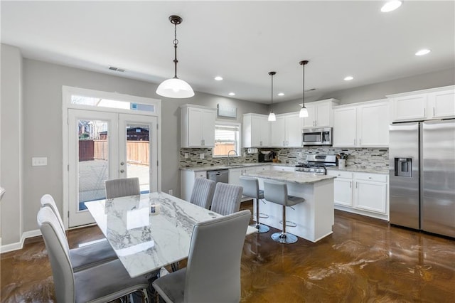 dining space with french doors and sink