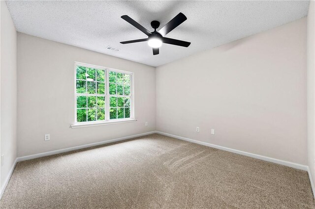 89 Prospect Path, Hiram, GA 30141 - carpeted spare room with baseboards, a textured ceiling, and a ceiling fan
