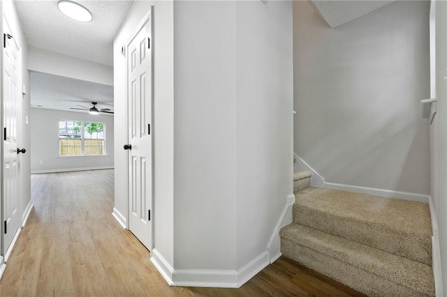 89 Prospect Path, Hiram, GA 30141 - corridor featuring light wood-type flooring, baseboards, stairs, and a textured ceiling