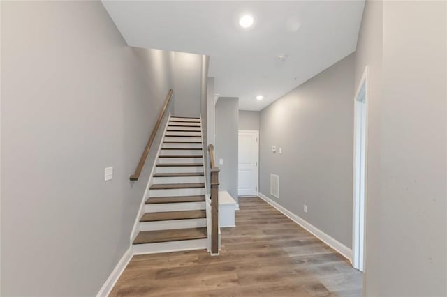 staircase featuring hardwood / wood-style flooring