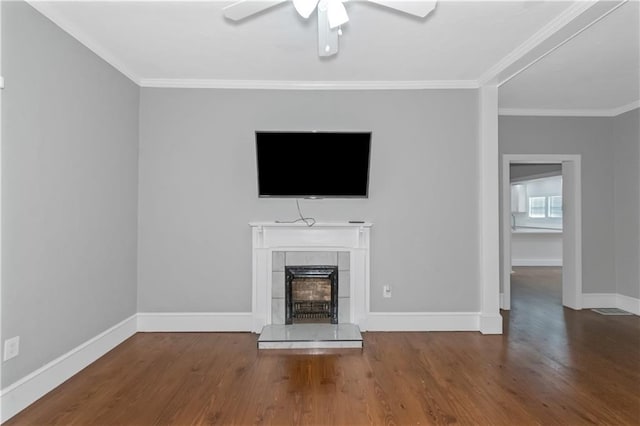 unfurnished living room featuring baseboards, a fireplace, wood finished floors, and crown molding