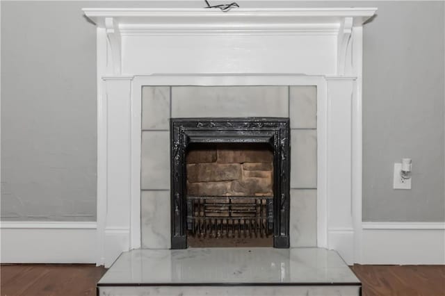 interior details featuring a fireplace and wood finished floors