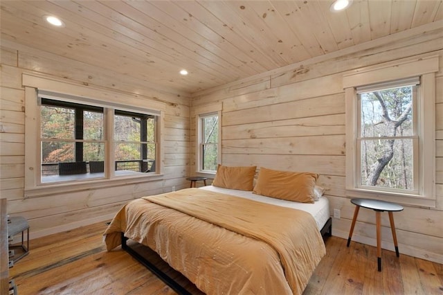 bedroom with baseboards, wood walls, wood ceiling, recessed lighting, and hardwood / wood-style flooring