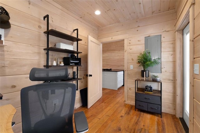 office area featuring wooden walls, wooden ceiling, and light wood-type flooring