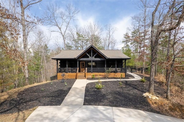 view of front of home featuring a porch and log exterior