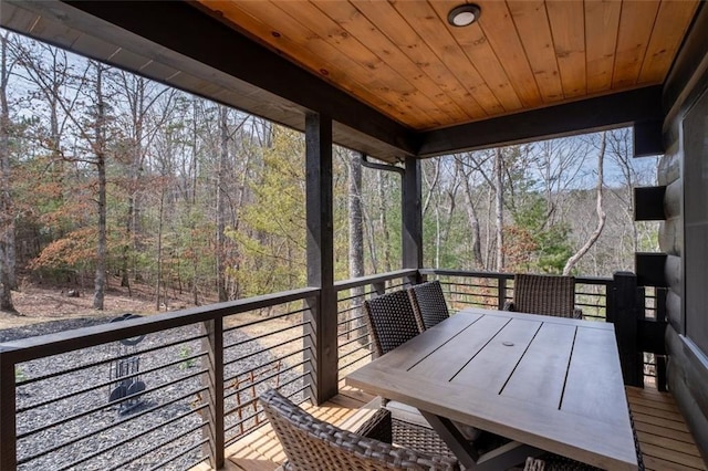 wooden deck featuring outdoor dining area