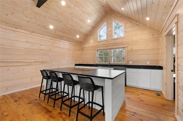 kitchen with dark countertops, white cabinets, and light wood-style flooring