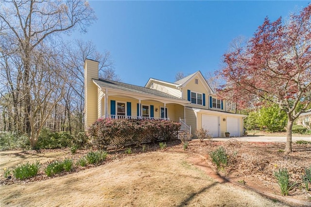 45 Somerset Ct, Covington, GA 30016 - view of front of house with a porch, concrete driveway, a garage, and a chimney