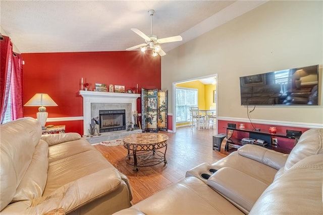 45 Somerset Ct, Covington, GA 30016 - living room with high vaulted ceiling, a tiled fireplace, wood finished floors, and ceiling fan
