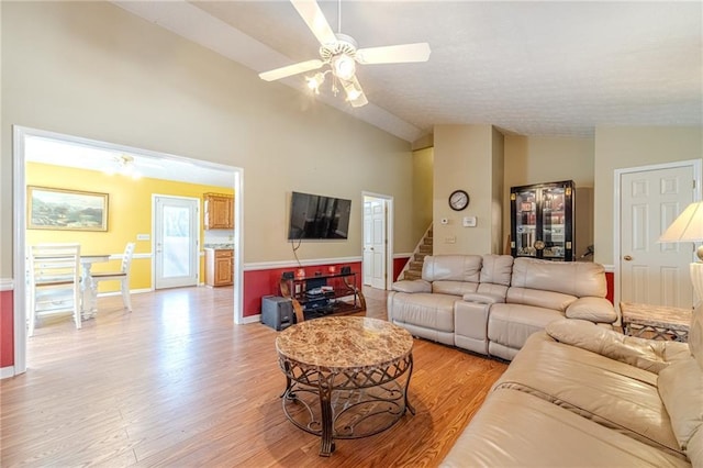 45 Somerset Ct, Covington, GA 30016 - living room with high vaulted ceiling, light wood-style flooring, baseboards, stairs, and a ceiling fan