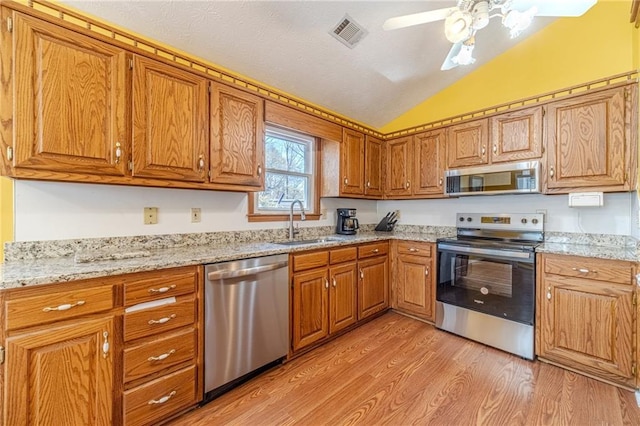 45 Somerset Ct, Covington, GA 30016 - kitchen featuring a sink, stainless steel appliances, brown cabinetry, and visible vents