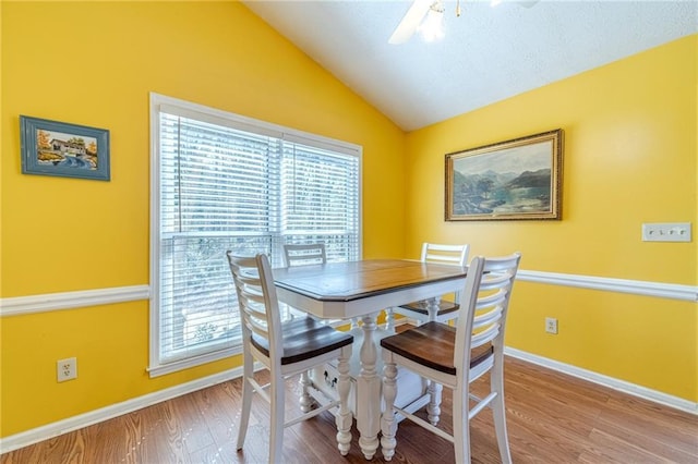 45 Somerset Ct, Covington, GA 30016 - dining room featuring plenty of natural light, baseboards, vaulted ceiling, and wood finished floors