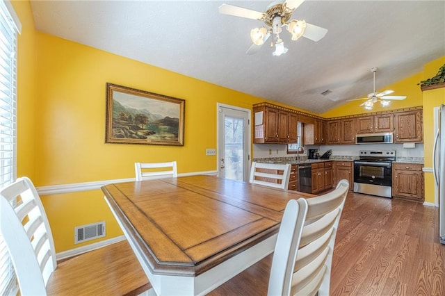 45 Somerset Ct, Covington, GA 30016 - dining space with vaulted ceiling, a ceiling fan, baseboards, visible vents, and dark wood-type flooring