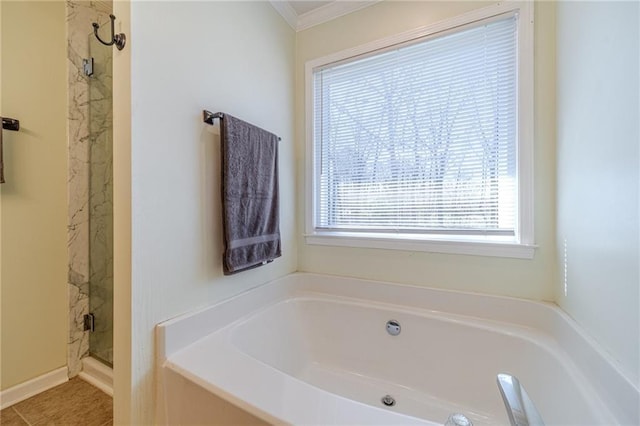 45 Somerset Ct, Covington, GA 30016 - bathroom featuring tile patterned flooring, ornamental molding, a stall shower, and a bath