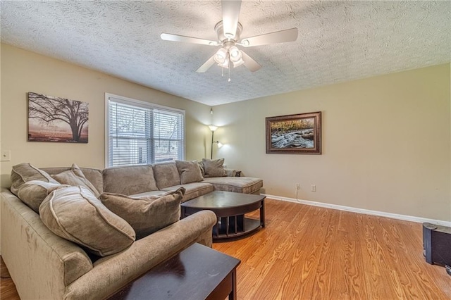 45 Somerset Ct, Covington, GA 30016 - living room with a ceiling fan, a textured ceiling, baseboards, and light wood-type flooring