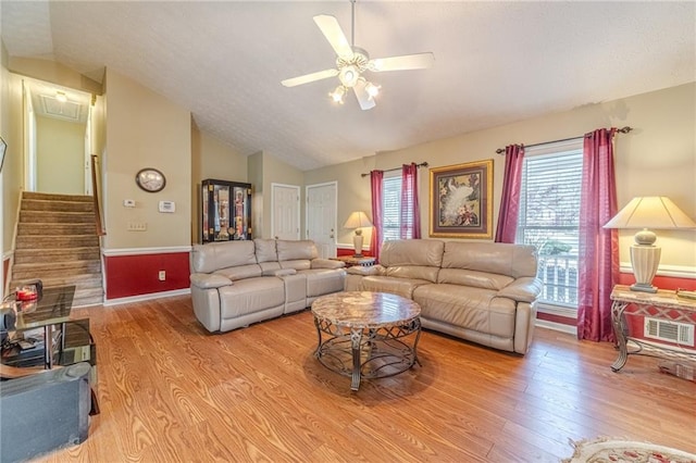 45 Somerset Ct, Covington, GA 30016 - living area featuring stairs, wood finished floors, lofted ceiling, visible vents, and ceiling fan