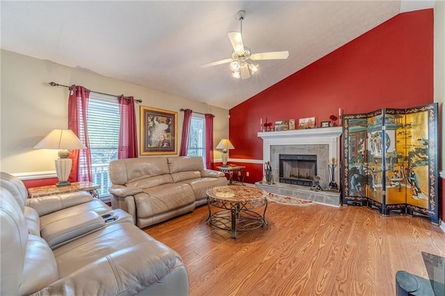 45 Somerset Ct, Covington, GA 30016 - living room featuring a fireplace with raised hearth, lofted ceiling, ceiling fan, and wood finished floors