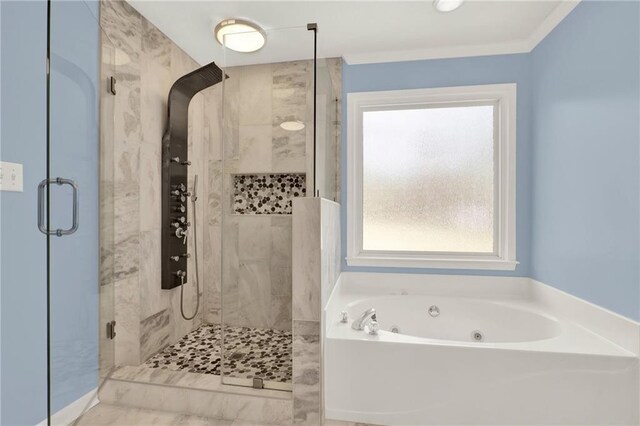 bathroom featuring ornamental molding and shower with separate bathtub