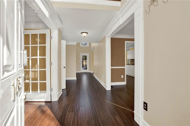 hallway with dark hardwood / wood-style flooring and crown molding