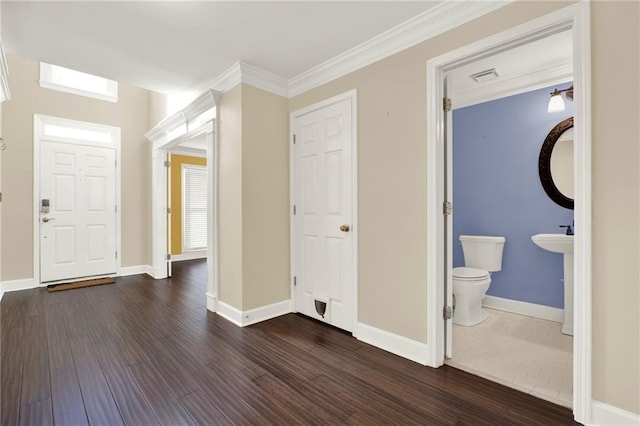 interior space with dark hardwood / wood-style floors and ornamental molding