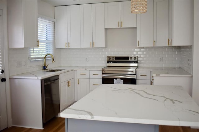 kitchen featuring hanging light fixtures, black dishwasher, a kitchen island, electric stove, and white cabinets