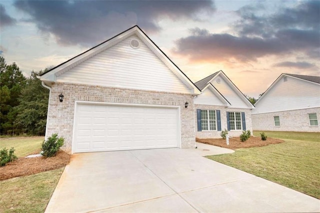 ranch-style home with a lawn and a garage