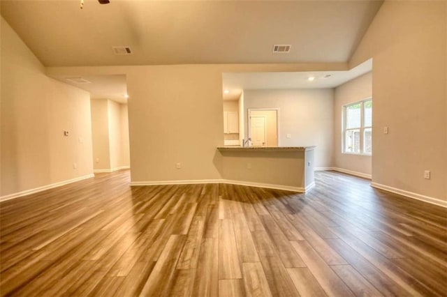 960 Park Place St, Social Circle, GA 30025 - unfurnished living room featuring dark wood finished floors, baseboards, and vaulted ceiling