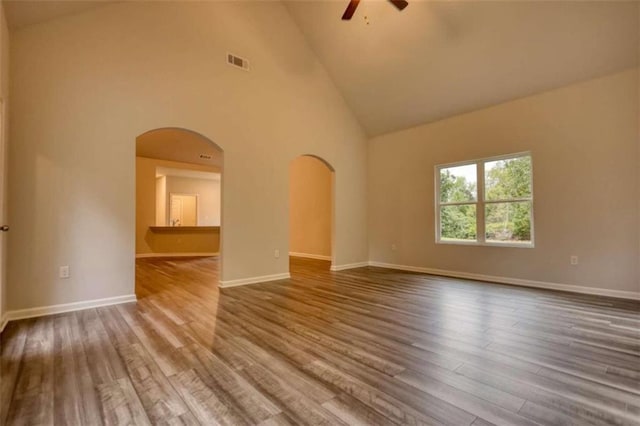 960 Park Place St, Social Circle, GA 30025 - unfurnished room featuring arched walkways, ceiling fan, high vaulted ceiling, wood finished floors, and baseboards