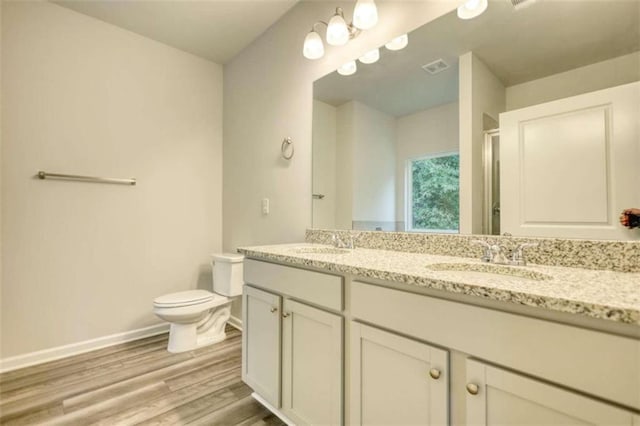 960 Park Place St, Social Circle, GA 30025 - bathroom with double vanity, toilet, baseboards, a shower with shower door, and wood finished floors
